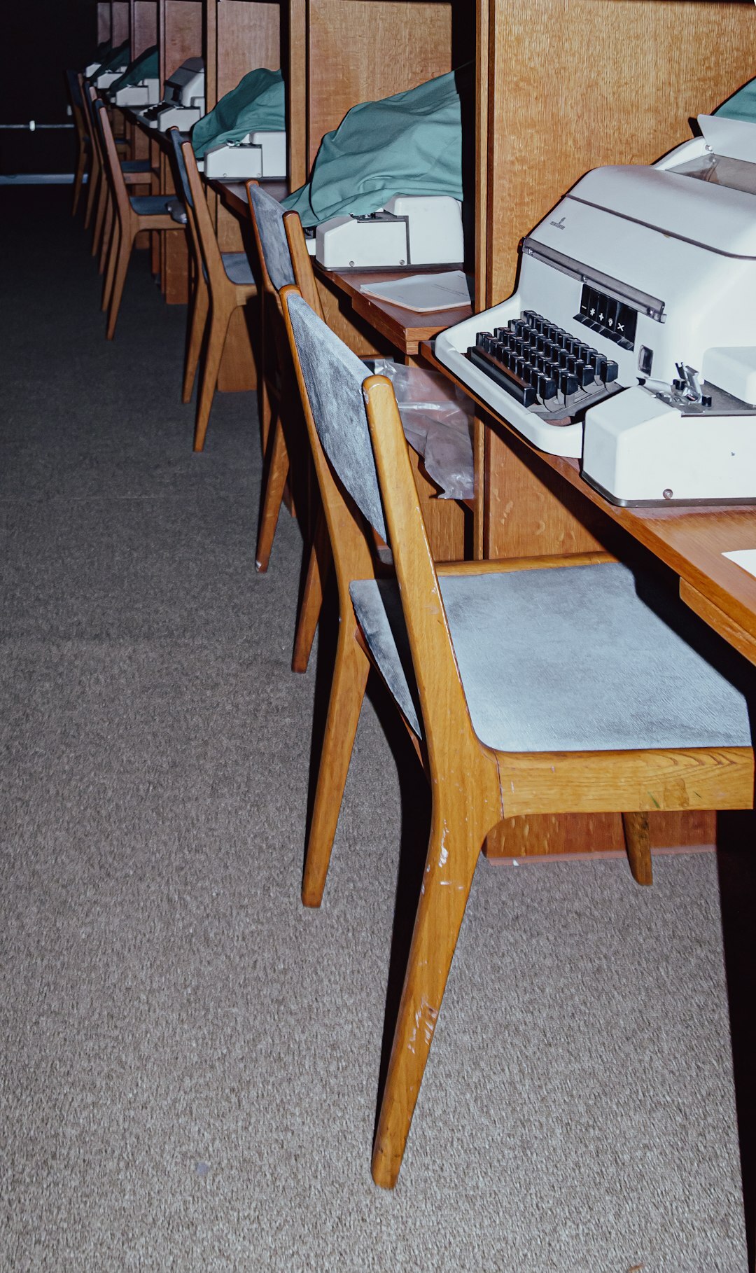 Modern open-plan newsroom office with desks and screens